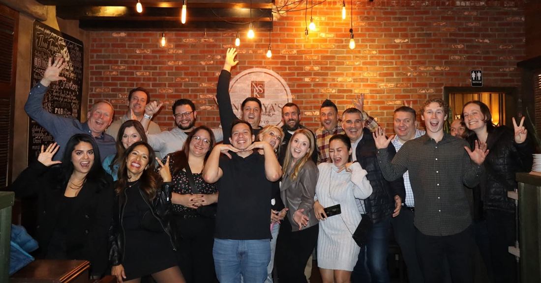 Jenny celebrating at a team dinner with colleagues
